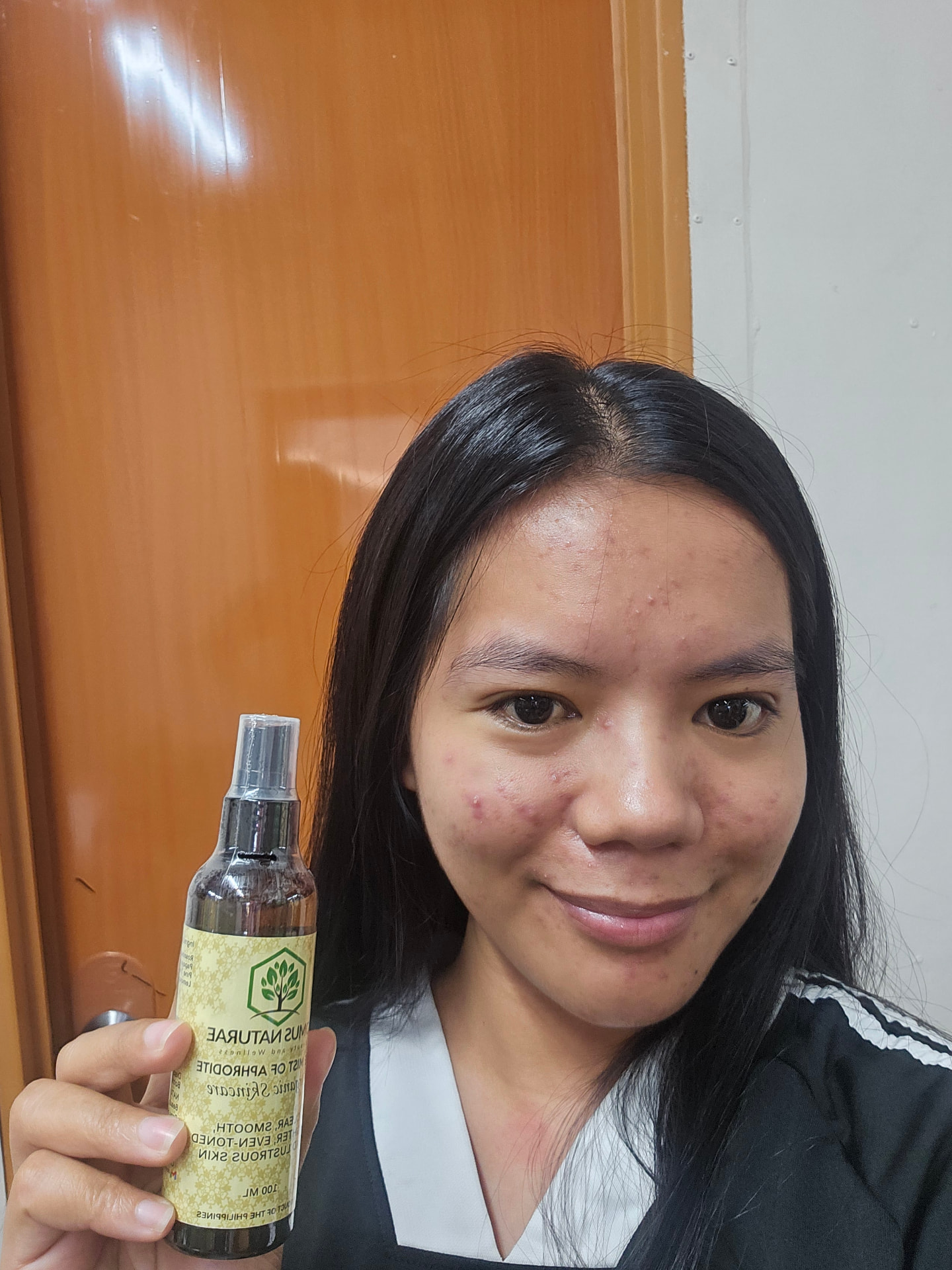 Customer holding Mist of Aphrodite before beginning her personal skincare journey